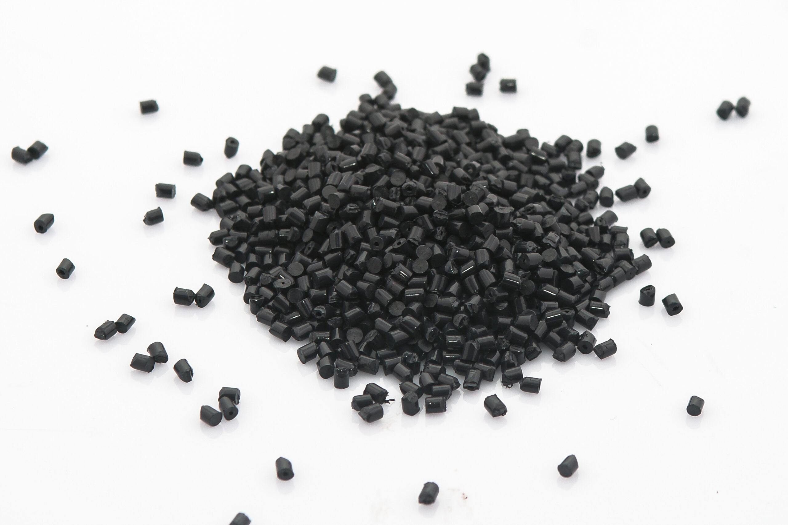 EPDM rubber granules .Black Colored Rubber Granules on white background. Plastic polymer granules.